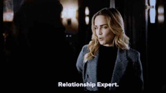 two women are standing next to each other and one of them is saying relationship expert