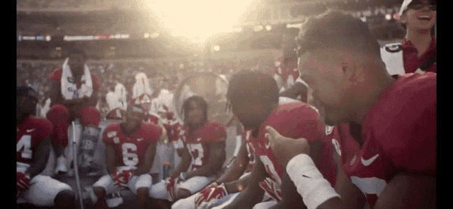 a group of football players are kneeling down and one of them has the number 7 on his jersey