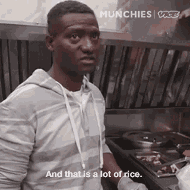 a man is standing in front of a stove with the words and that is a lot of rice on the bottom