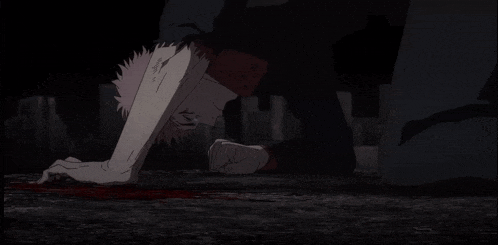 a man is kneeling on the ground with blood coming out of his mouth