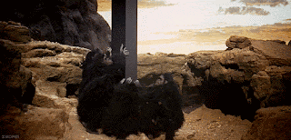 a group of people are reaching out from a hole in the rocks