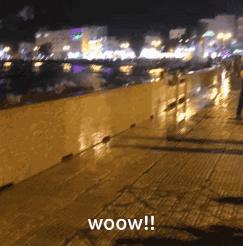 a blurred image of a city at night with the words woow