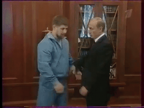 a man in a blue jacket is standing next to another man