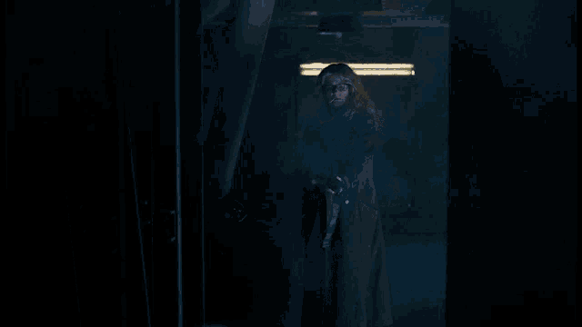 a woman smoking a cigarette and holding a shotgun in a dark room