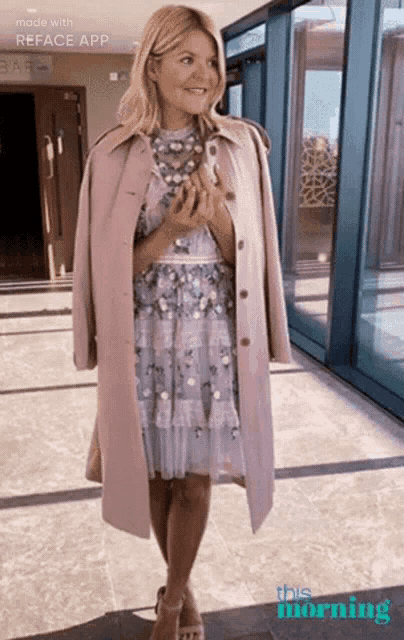 a woman wearing a dress and a trench coat is standing in front of a building that says this morning on it