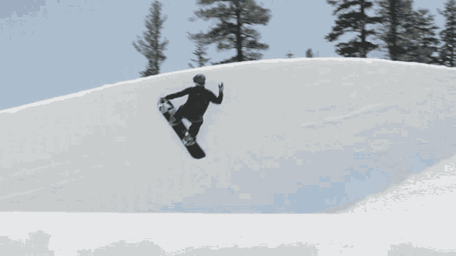 a snowboarder is doing a trick in the snow