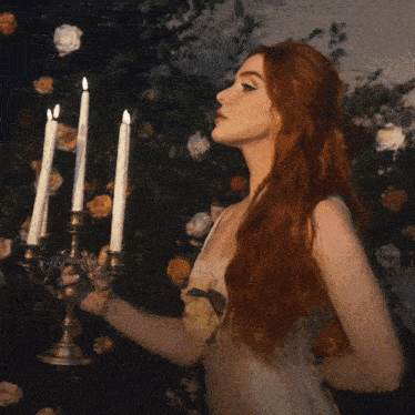 caylee hammack 's bed of roses album cover features a woman holding three candles
