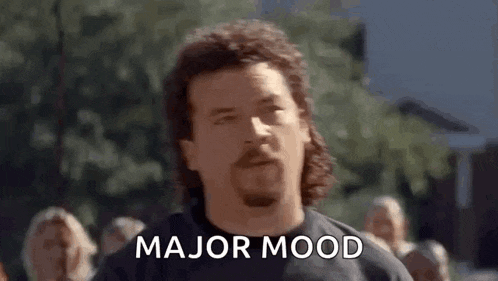 a man with a mullet and a beard is saying `` major mood '' .
