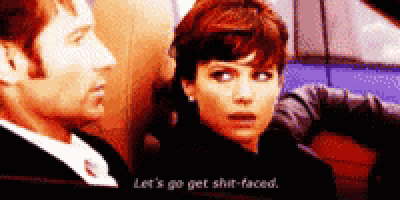a man and woman are sitting next to each other and the woman is saying let 's go get shit faced