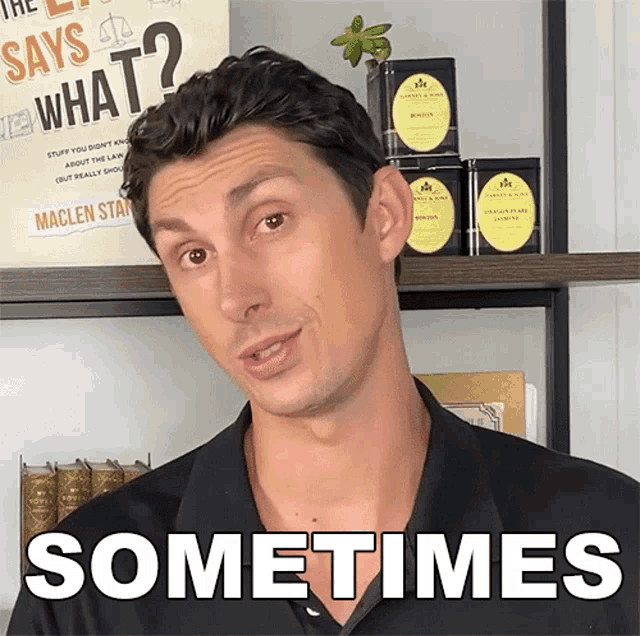 a man is standing in front of a sign that says " says what "