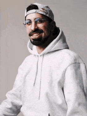 a man wearing a red bull hat and a grey carhartt hoodie