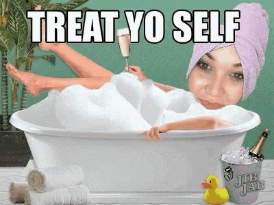 a woman in a bathtub with a towel wrapped around her head holding a glass of champagne