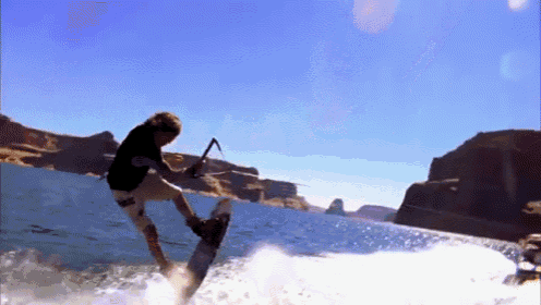 a man is riding a wave on a wakeboard