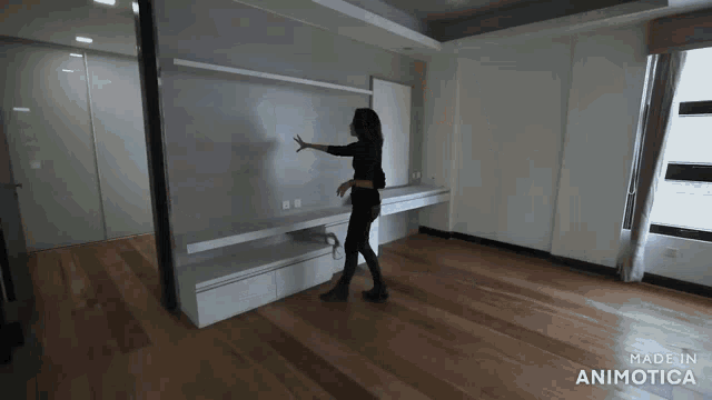 a woman is standing in a room with the words made in animotica on the bottom right
