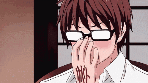 a man wearing glasses is covering his face with his hand and has a tattoo on his arm .