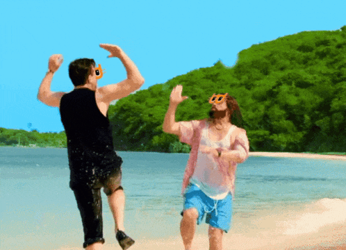 two men are dancing on a beach and one has sunglasses on