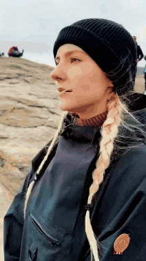 a woman with braids wearing a black beanie