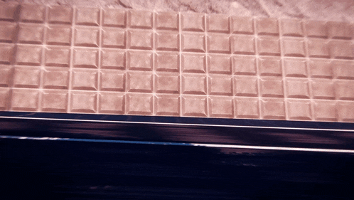 a close up of a chocolate bar that looks like a brick wall