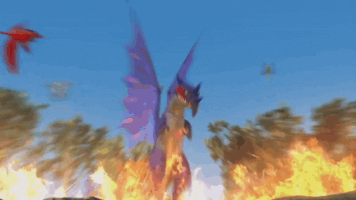 a group of dragons are flying over a forest with fire