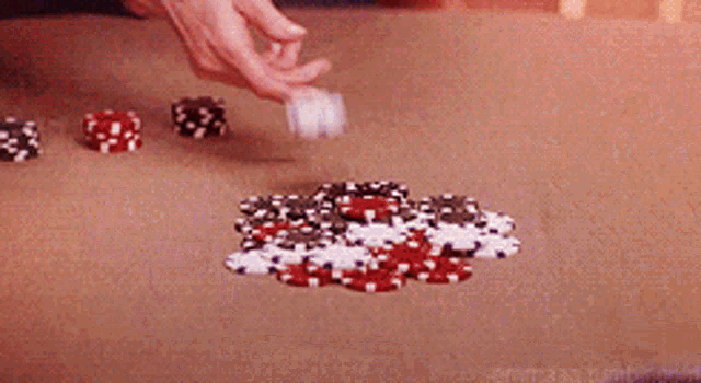 a pile of poker chips on a table with a blurred background