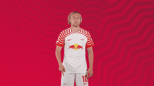 a man wearing a red and white jersey with the number 18
