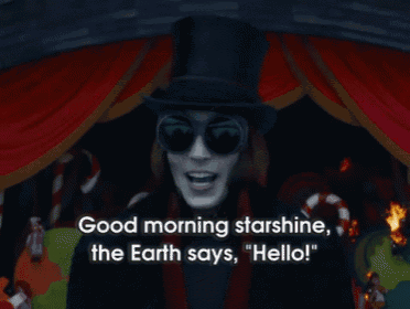 a man wearing sunglasses and a top hat says good morning starshine the earth says hello