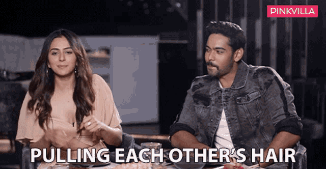 a man and a woman are sitting at a table with the words pulling each other 's hair