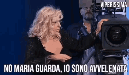 a woman is standing in front of a camera with the words viperissima written on the bottom