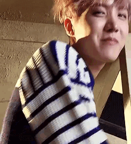 a close up of a person wearing a striped shirt
