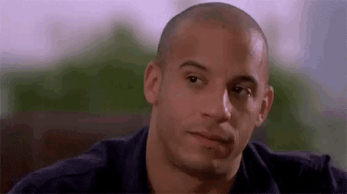 a close up of a man 's face with a bald head .
