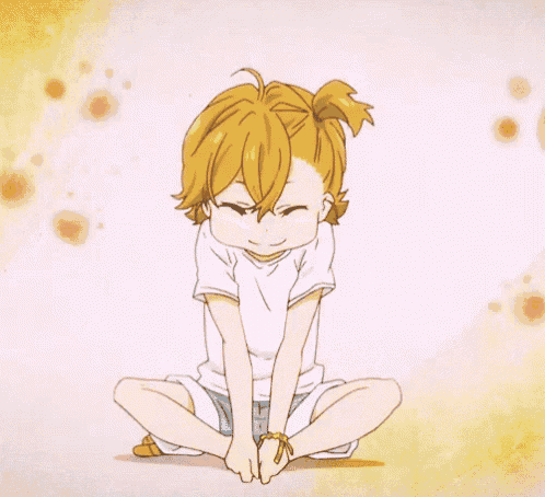 a girl with blonde hair is sitting on the floor with her legs crossed