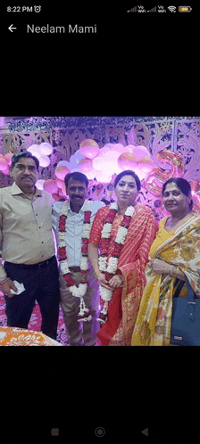 a group of people posing for a picture with the name neelam mami on the bottom left