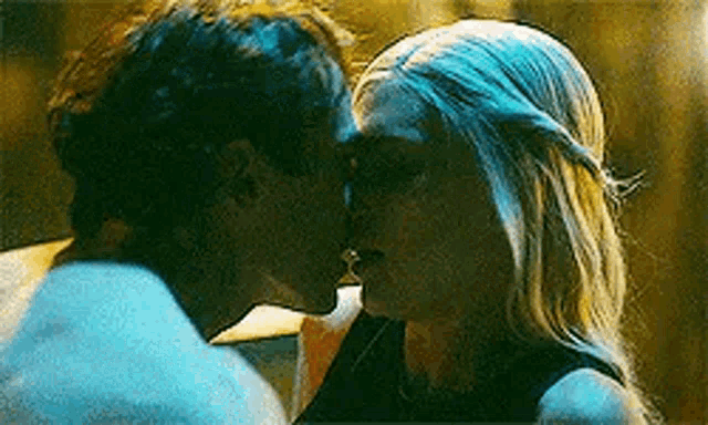 a man and a woman are kissing each other in a car .