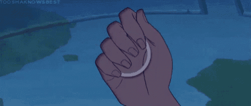 a person 's hand is holding a bracelet with purple beads on it .