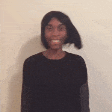 a blurry picture of a person wearing a black shirt and a wig
