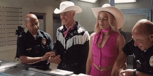 a man in a cowboy hat and a woman in a pink outfit are being questioned by police officers