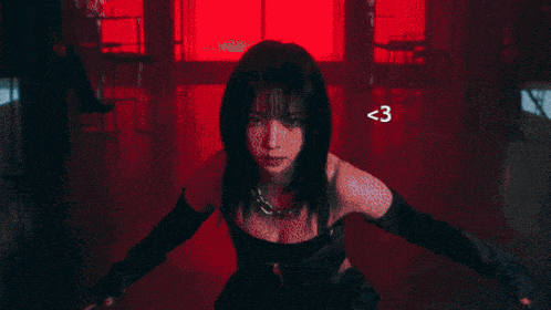 a woman in a corset is holding a sword in a black and white photo