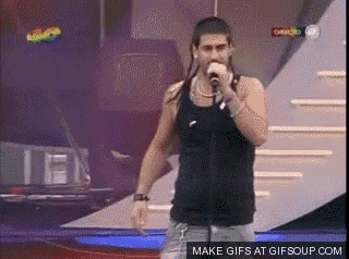 a man singing into a microphone with a make gifs at gifsoup.com button