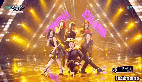 a group of people are performing on a stage with a sign that says shut up