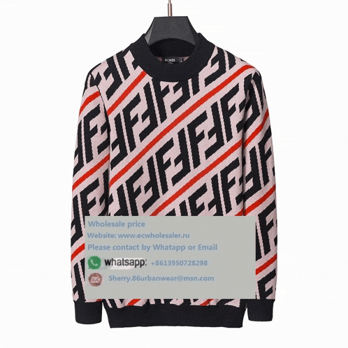 a sweater with a fendi logo on it hangs on a hanger