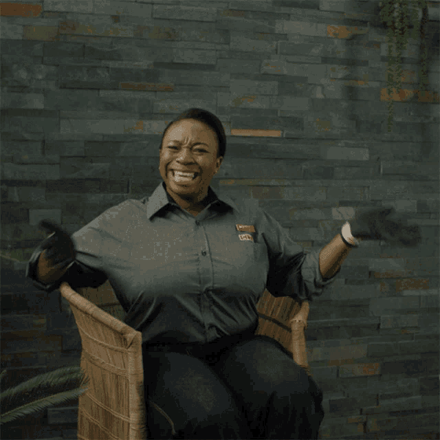 a woman sitting in a chair wearing a shirt that says gm