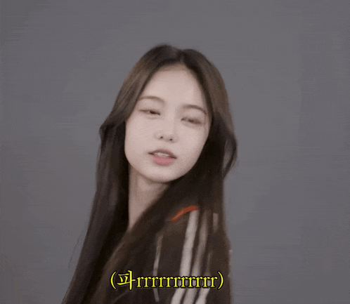 a girl with long hair is smiling and says rrrrrrrrr