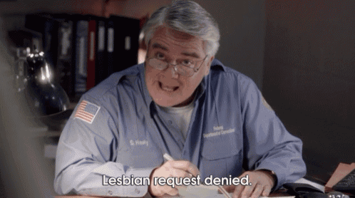 a man sitting at a desk with the words lesbian request denied