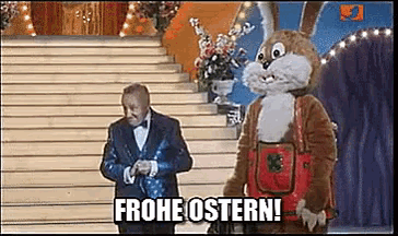 a man in a tuxedo stands next to a bunny mascot and says frohe ostern .