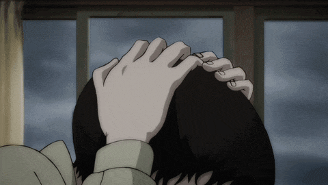 a close up of a person 's head with a hand on it