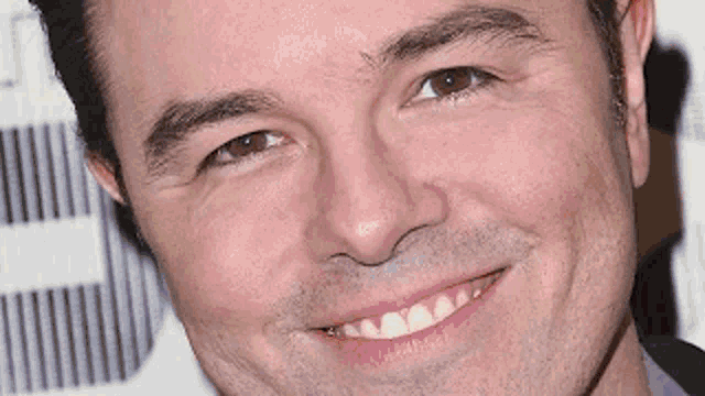 a close up of a man 's face with the letter e in the background