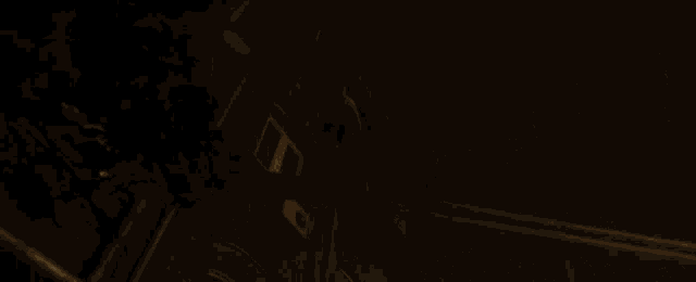 a man is laying on the floor in a dark room with a light shining on him .