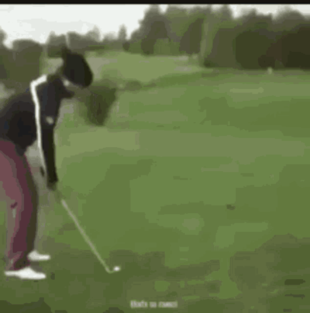 a man is jumping out of a golf cart while playing golf .