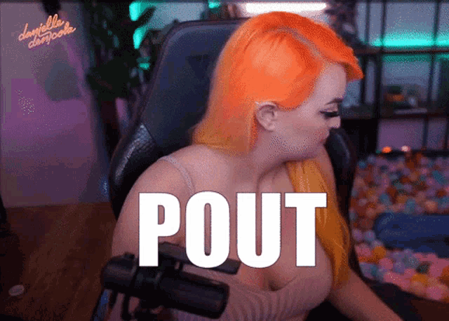 a woman with orange hair is sitting in front of a microphone with the word pout written on it