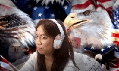 a woman is wearing headphones in front of an american flag .